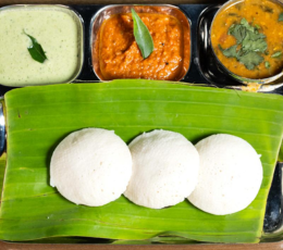 The tray was filled with various South Indian meals, including chutney, sambar, dosa, and idly