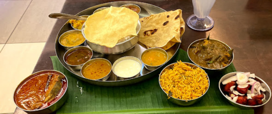 A dish on a table surrounded by bowls of different foods displays an appetizing and varied dinner