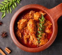 The spices, medicinal products, and chicken curry are in a clay bowl with chicken gravy on top