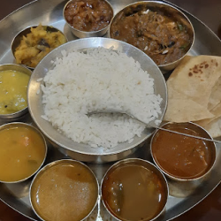 South Indian meal with rice, sambar, rasam, curries, vegetables & chutneys with delicious flavors.