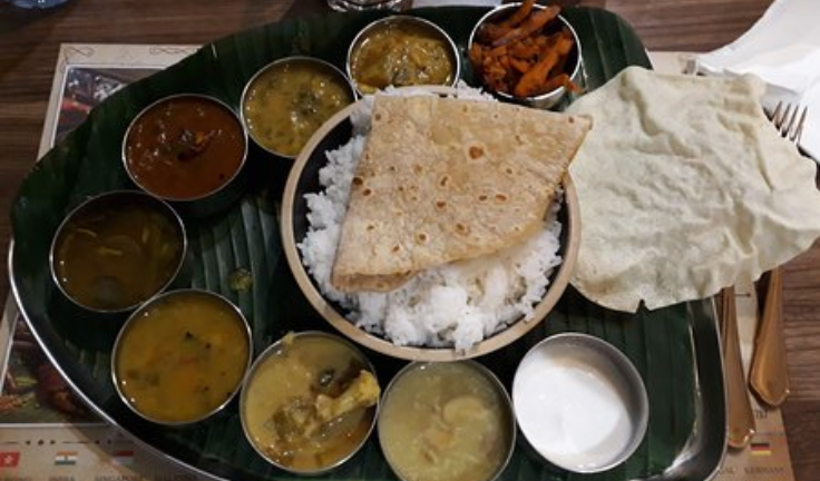A plate of rice & chapati with a variety of dals makes for a delicious lunch in Indian cuisine