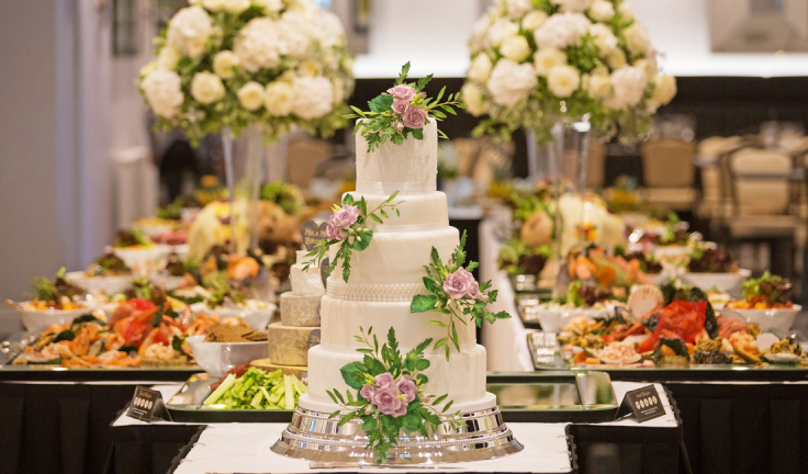 A beautifully decorated wedding cake showcased at a reception, adding elegance and sweetness.