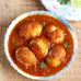 A dish consisting of ground pork served in a delicious sauce, called egg curry, in a bowl