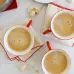 An ideal way to brighten up your morning is to have three cups of hot beverages placed on a wooden table